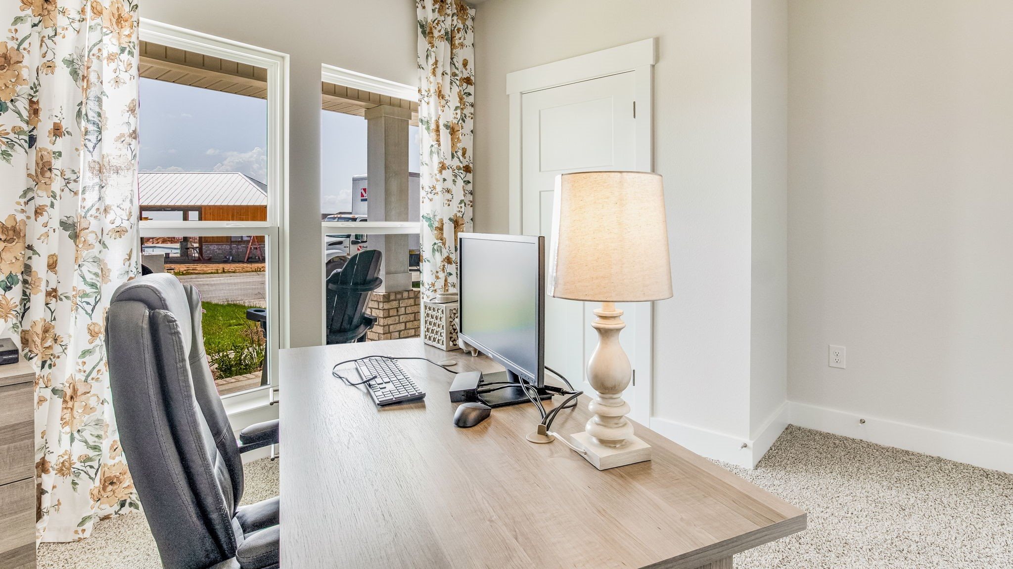 Bedroom that can be used as an office space with 2 large windows and closet in view.