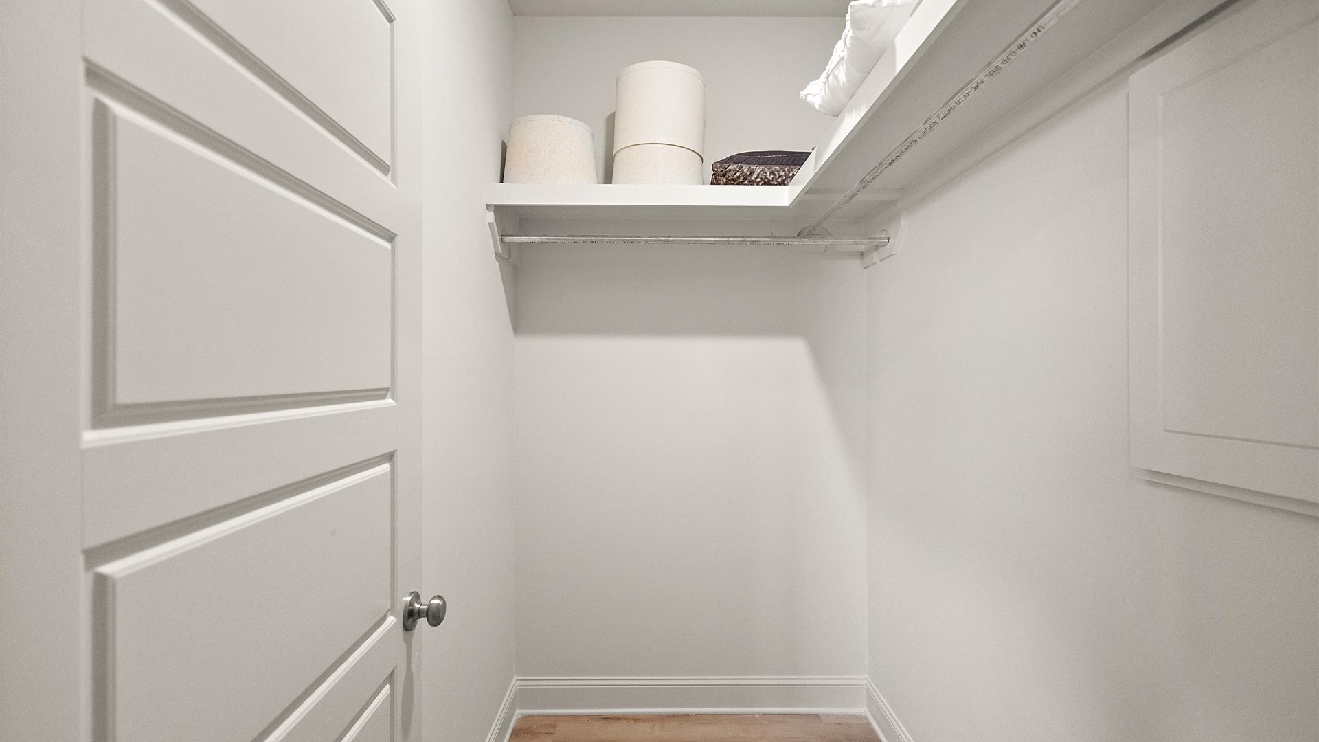 Utility laundry smartly designed with overhead storage, a drop zone, washer, dryer and hookups included