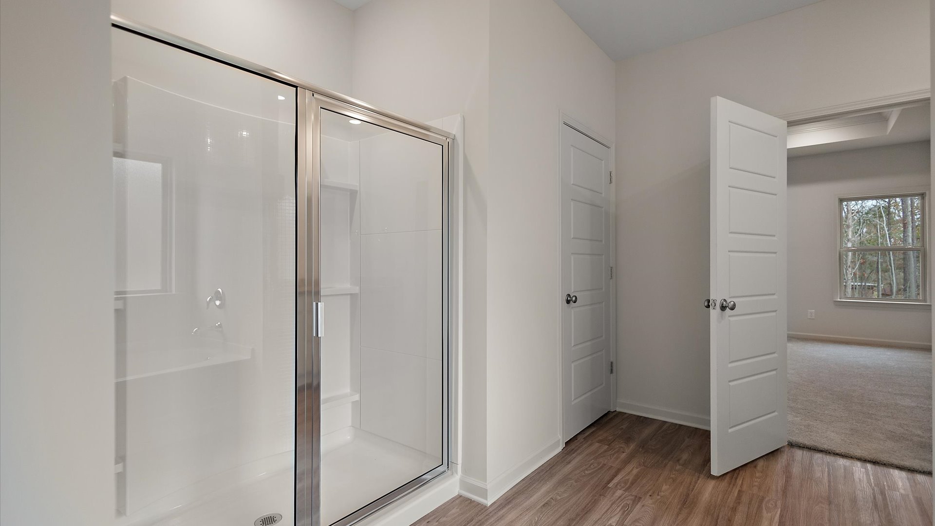 Walk-in shower with built-in shelving.