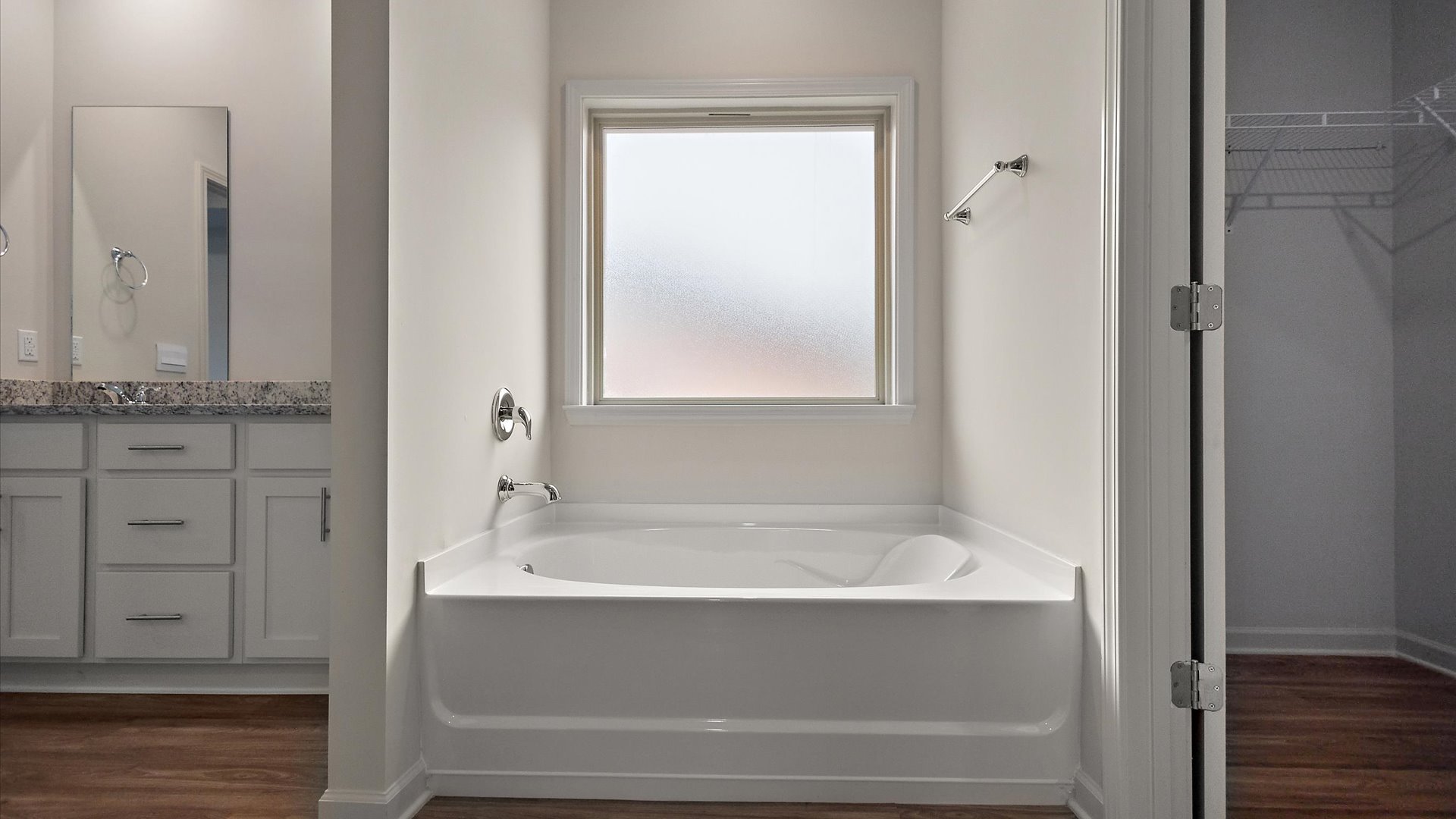 Garden tub with frosted overhead window for natural light.