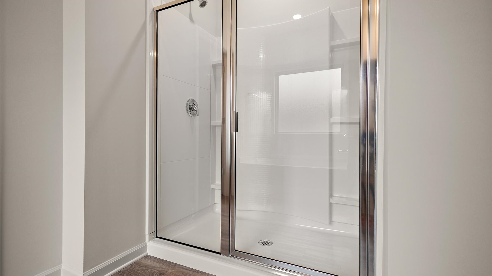 Walk-in shower with built-in shelving.