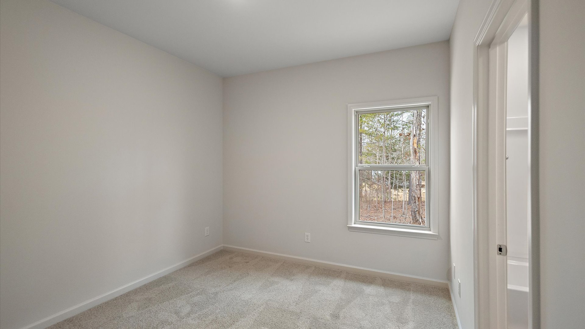 Additonal bedroom with carpeted floors, recessed lighting, and a window for natural light.