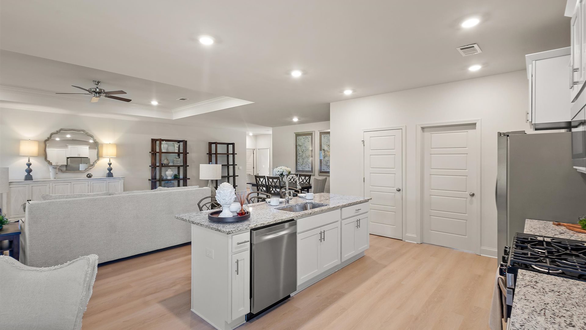 Spacious kitchen with granite countertops, island, and stainless-steel appliances.