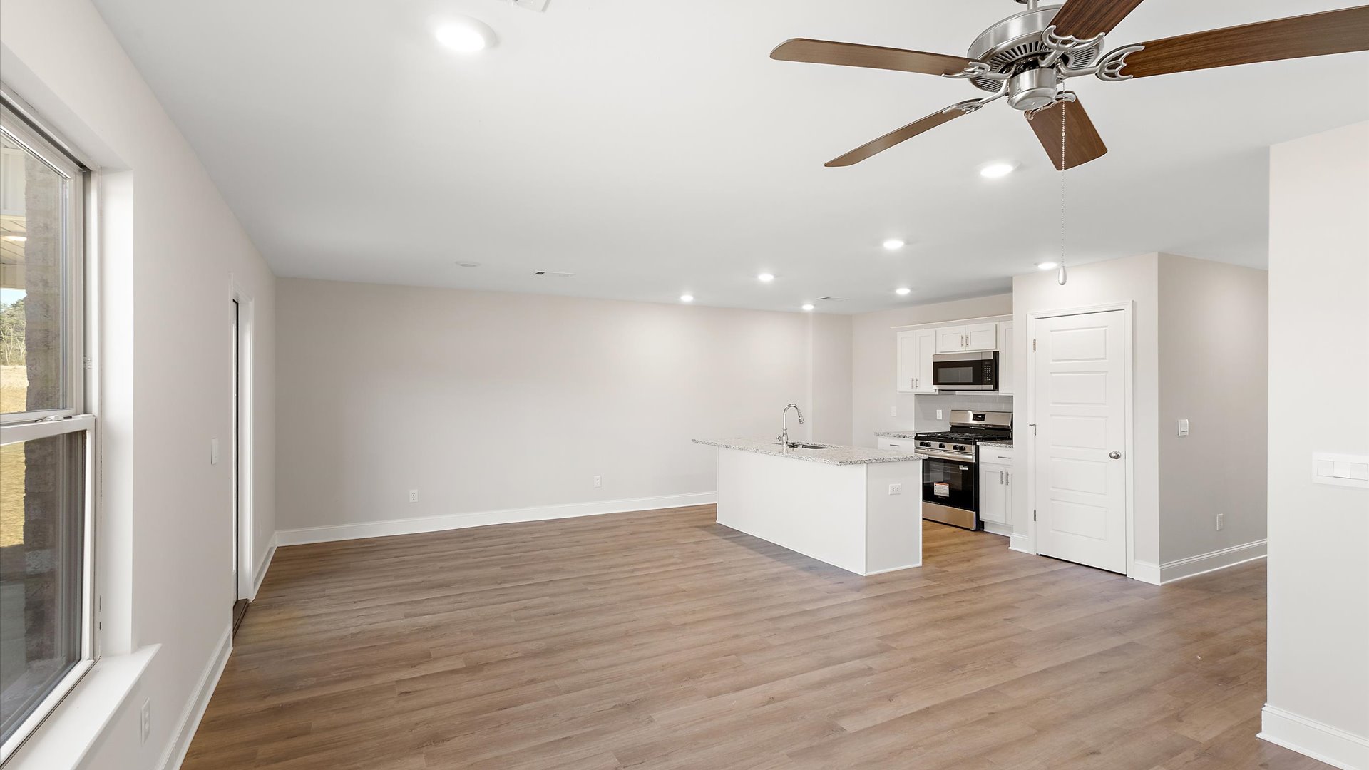 kitchen overlooking the living space with quartz countertops and stainless steel appliances