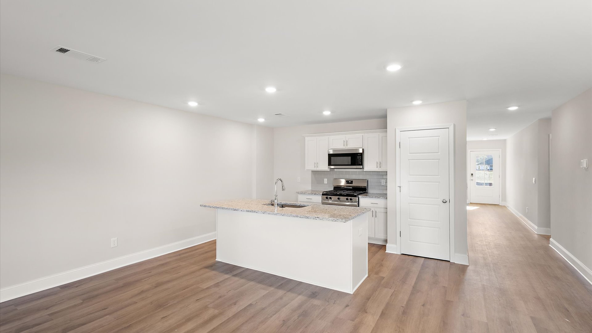 kitchen overlooking the living space with quartz countertops and stainless steel appliances
