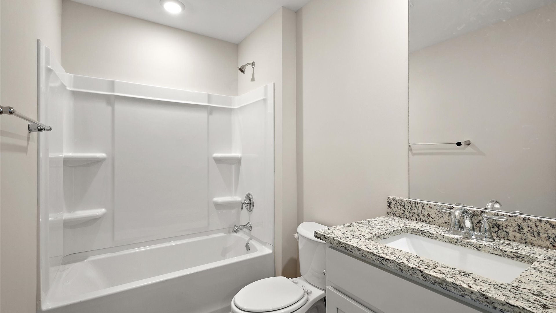hall bathroom with single vanity and shower/tub combo