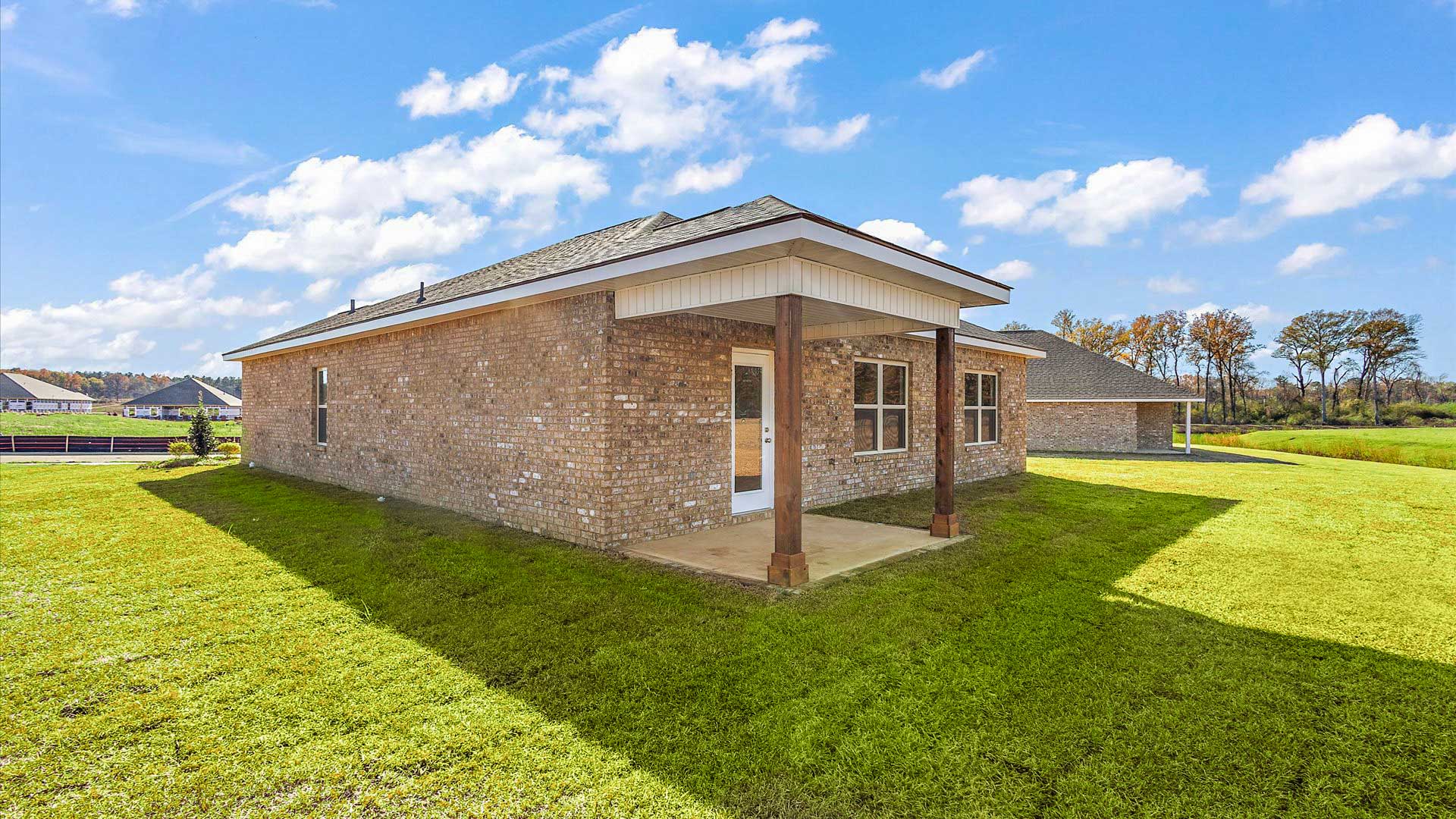 covered back porch opening up to greenspace