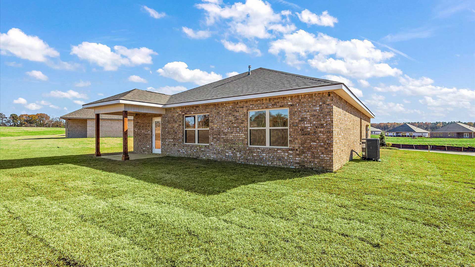 covered back porch opening up to greenspace