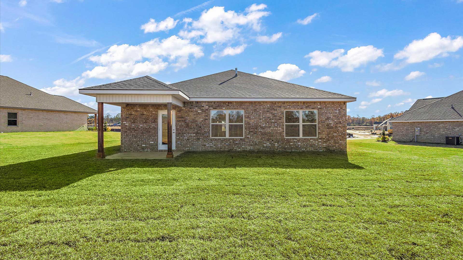 covered back porch opening up to greenspace