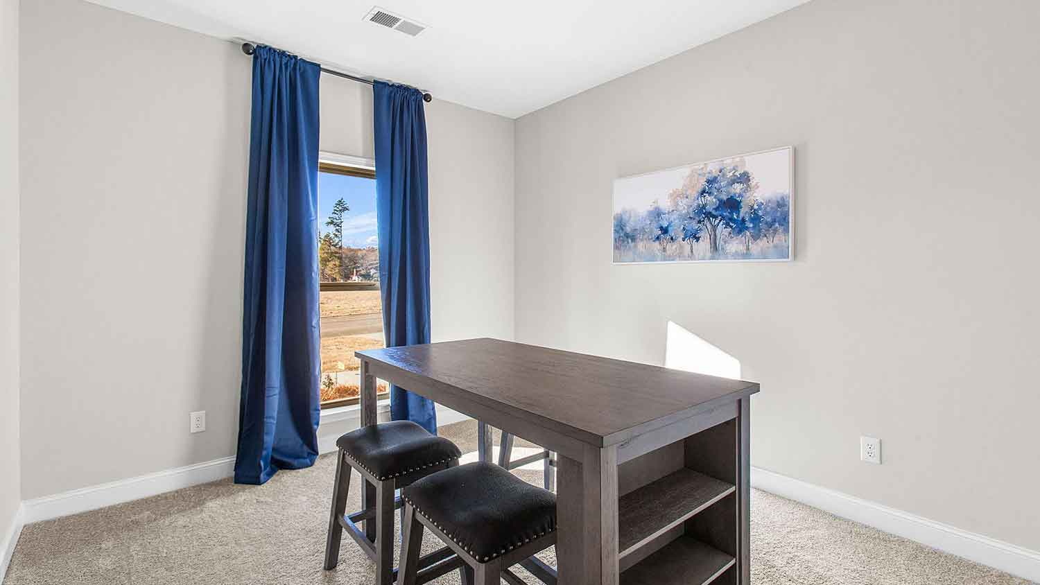 home office featuring a desk with 2 stools