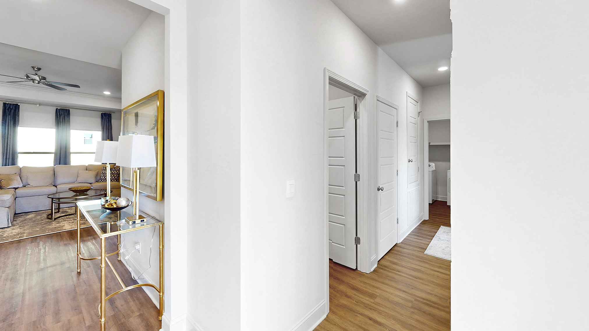 hall leading to additional bedrooms and laundry