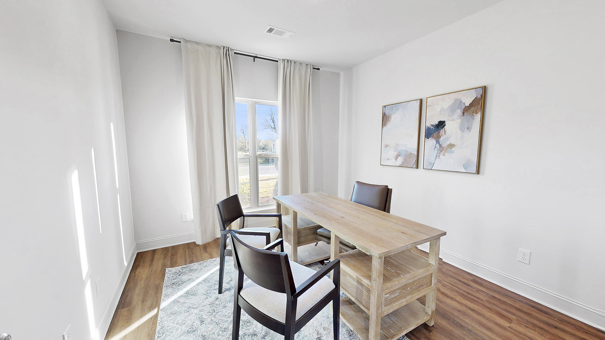 flex space being used as an office, with hardwood floors and window