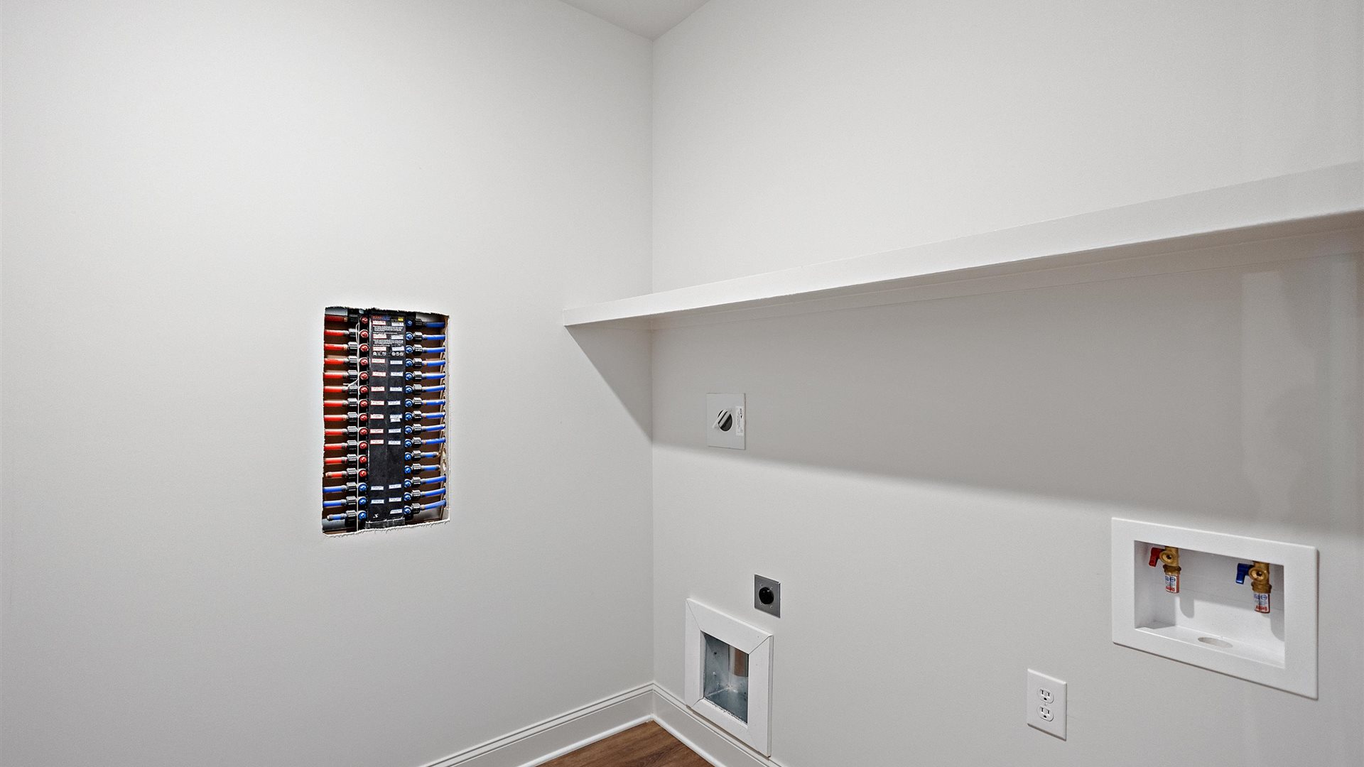spacious laundry room with built in shelves
