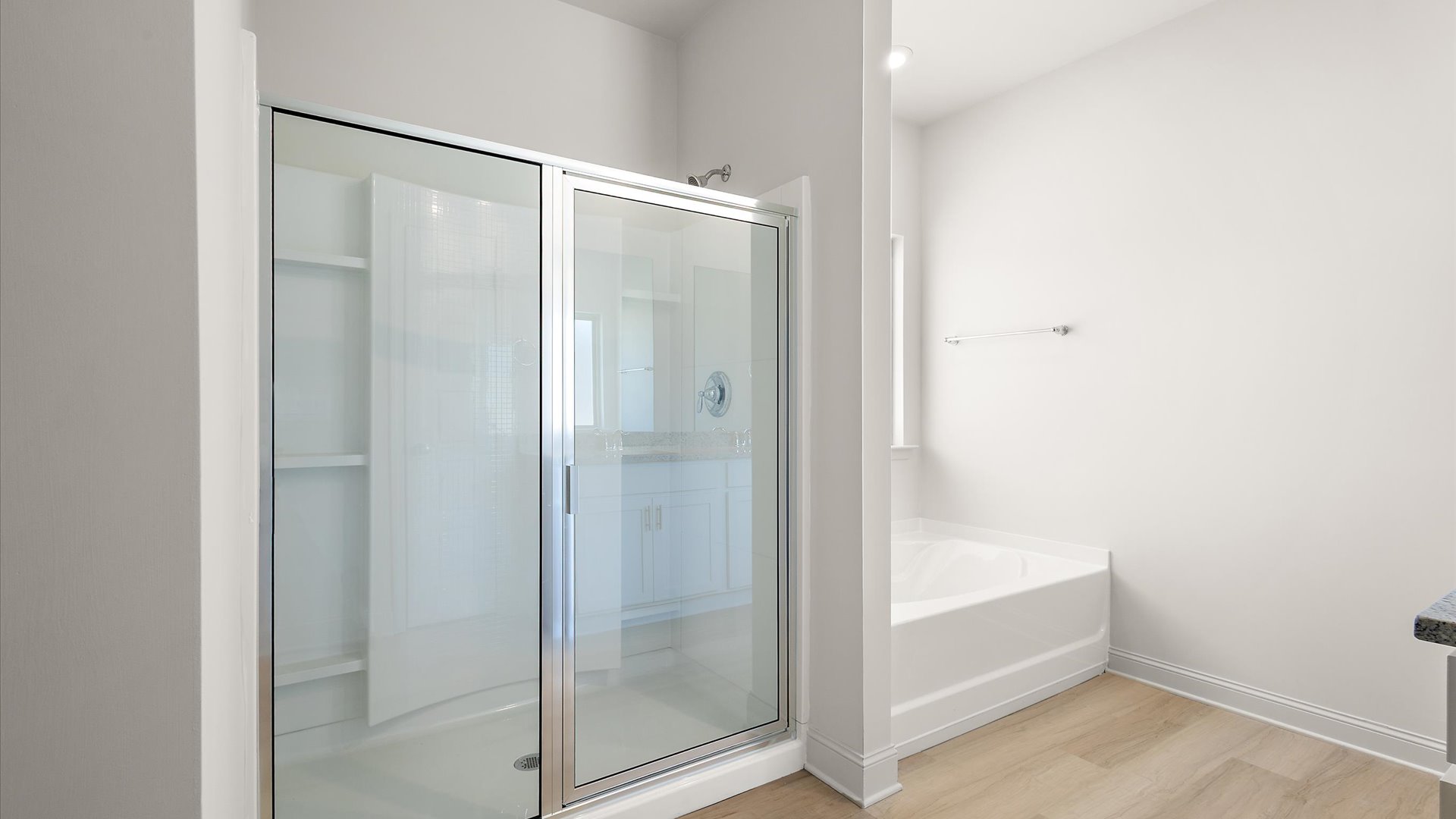 primary bathroom with walk in shower and adjacent garden tub