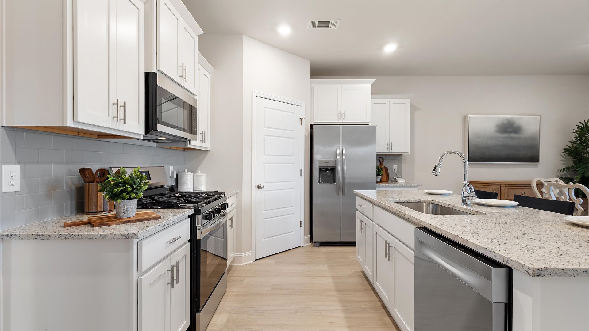open kitchen with soft close cabinets and stainless steel appliances