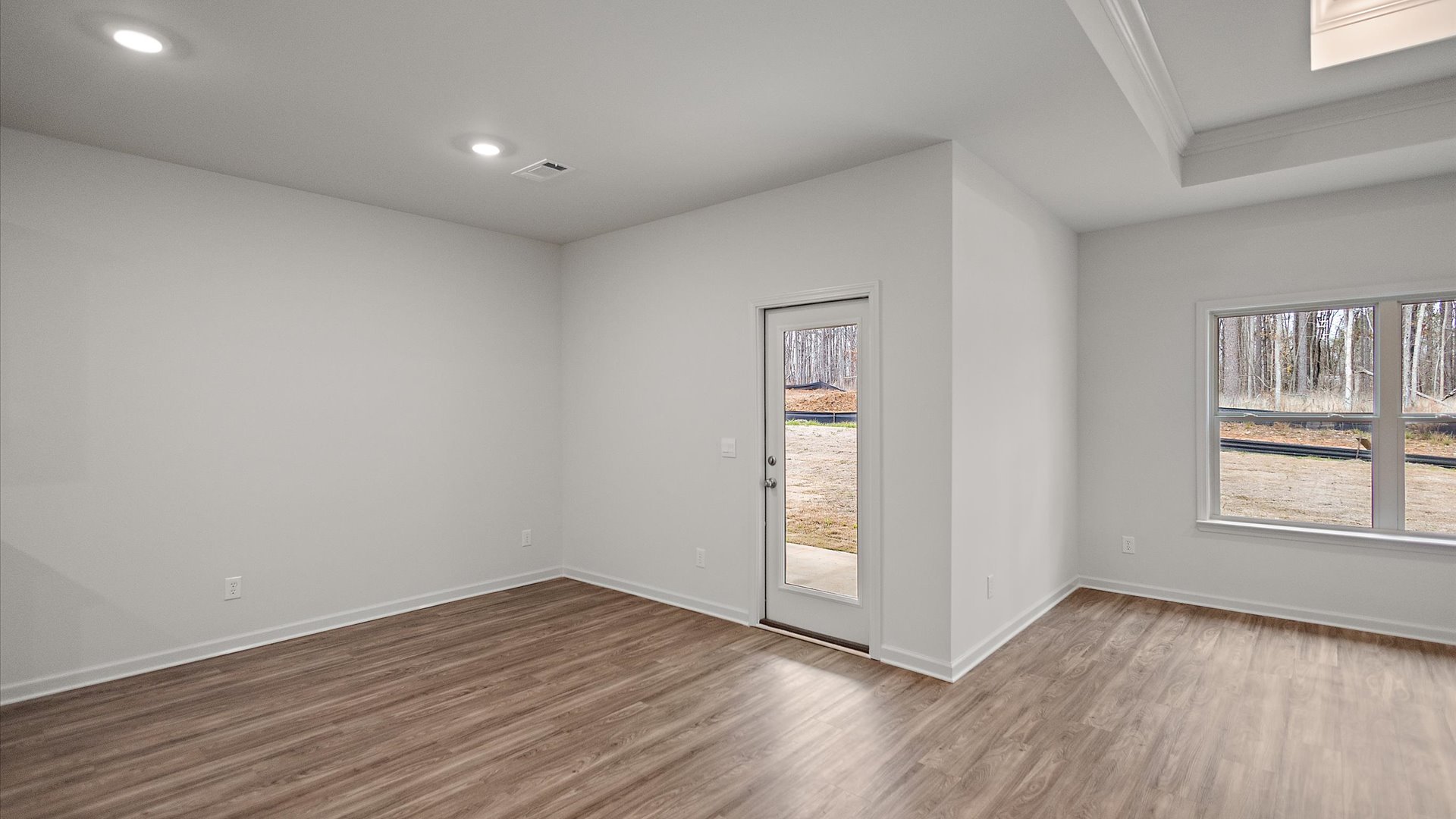 Breakfast nook area with recessed lighting with hardwood floors.