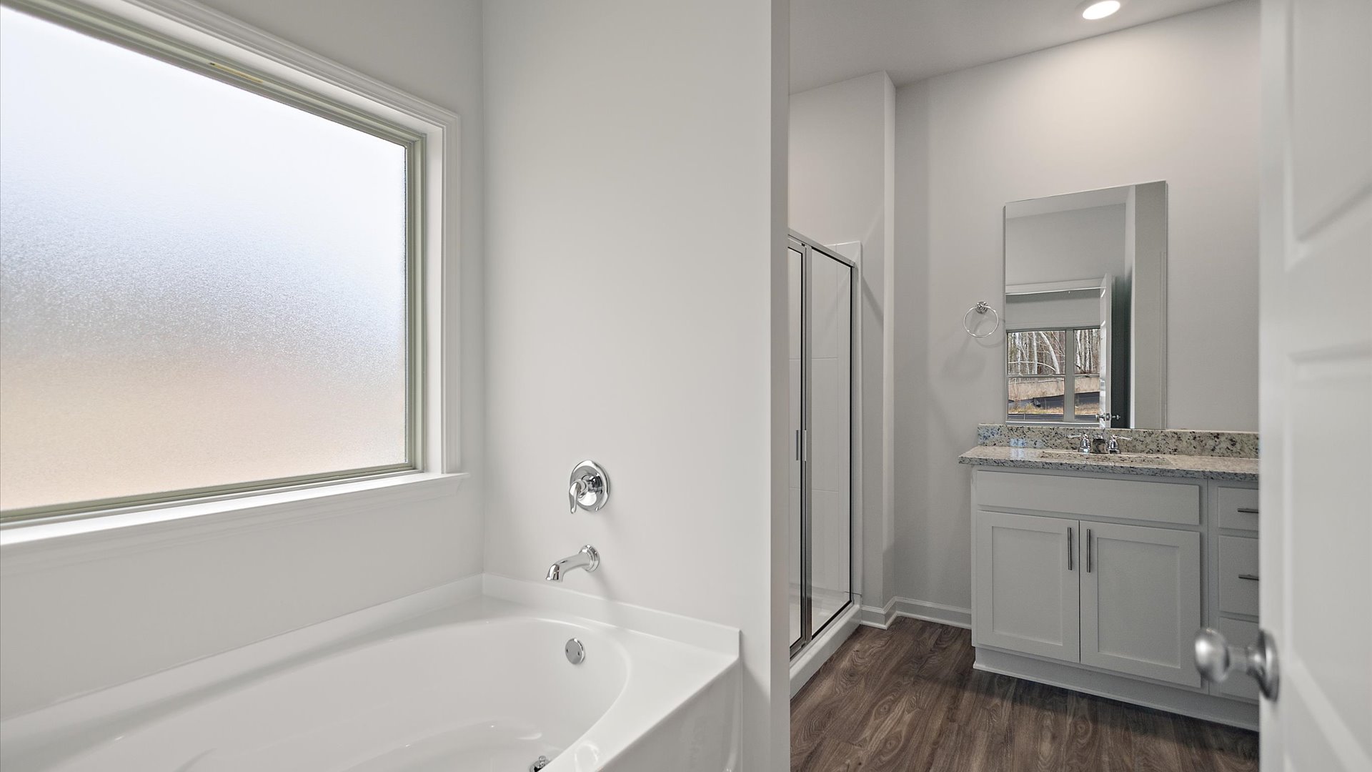 Garden tub with frosted overhead window for natural light.
