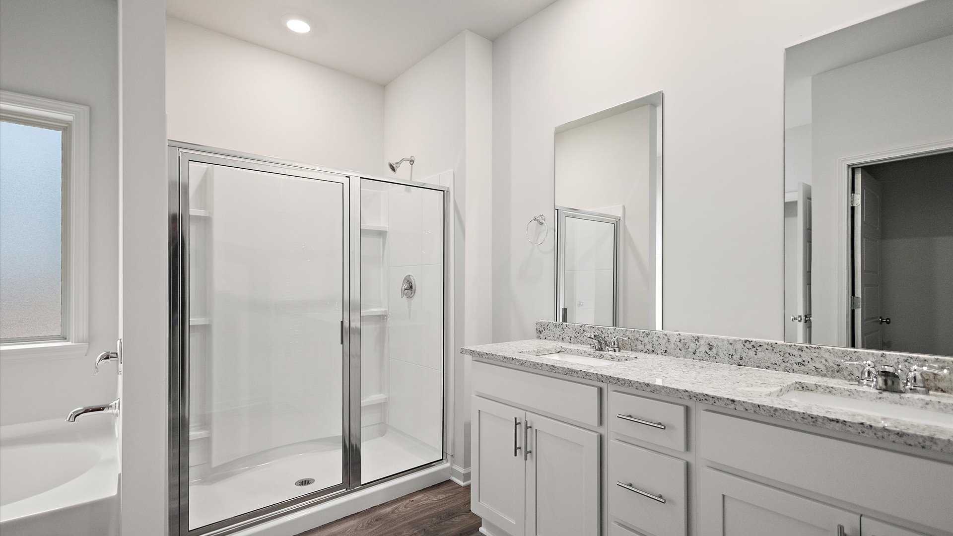 Walk-in shower with built-in shelving.