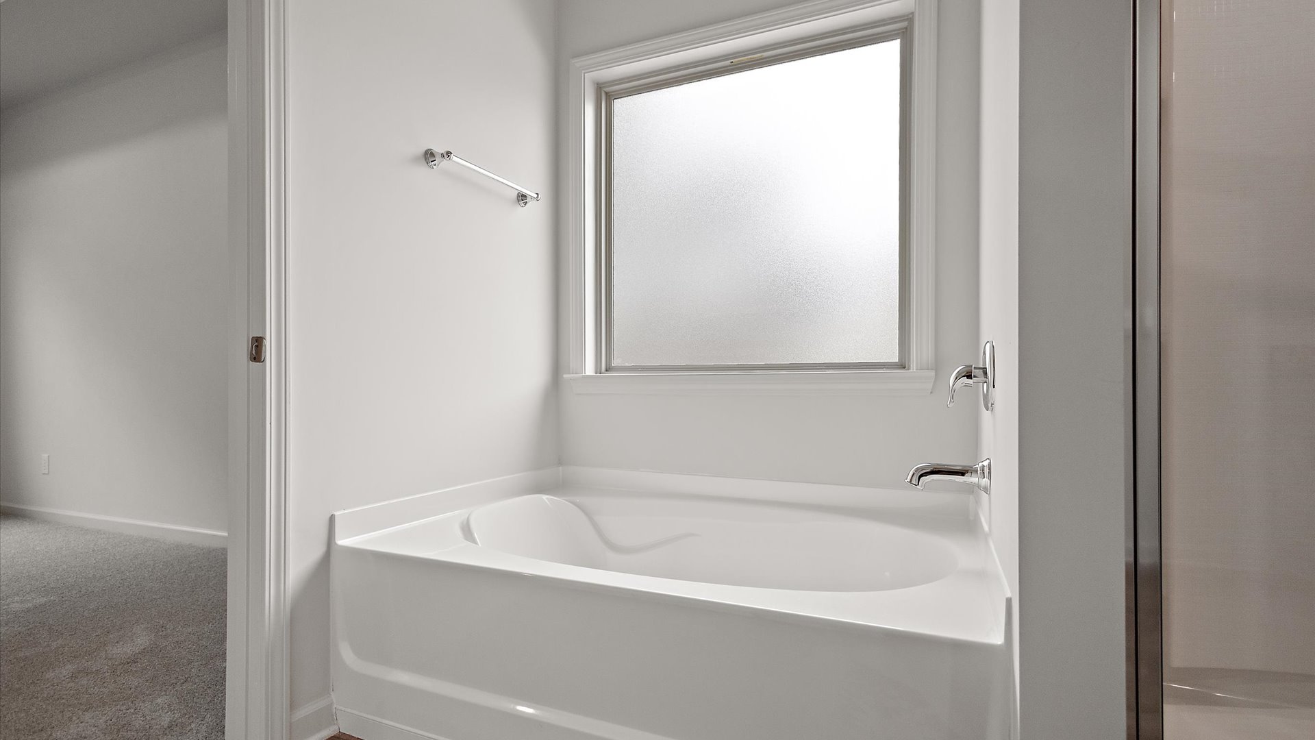 Garden tub with frosted overhead window for natural light.