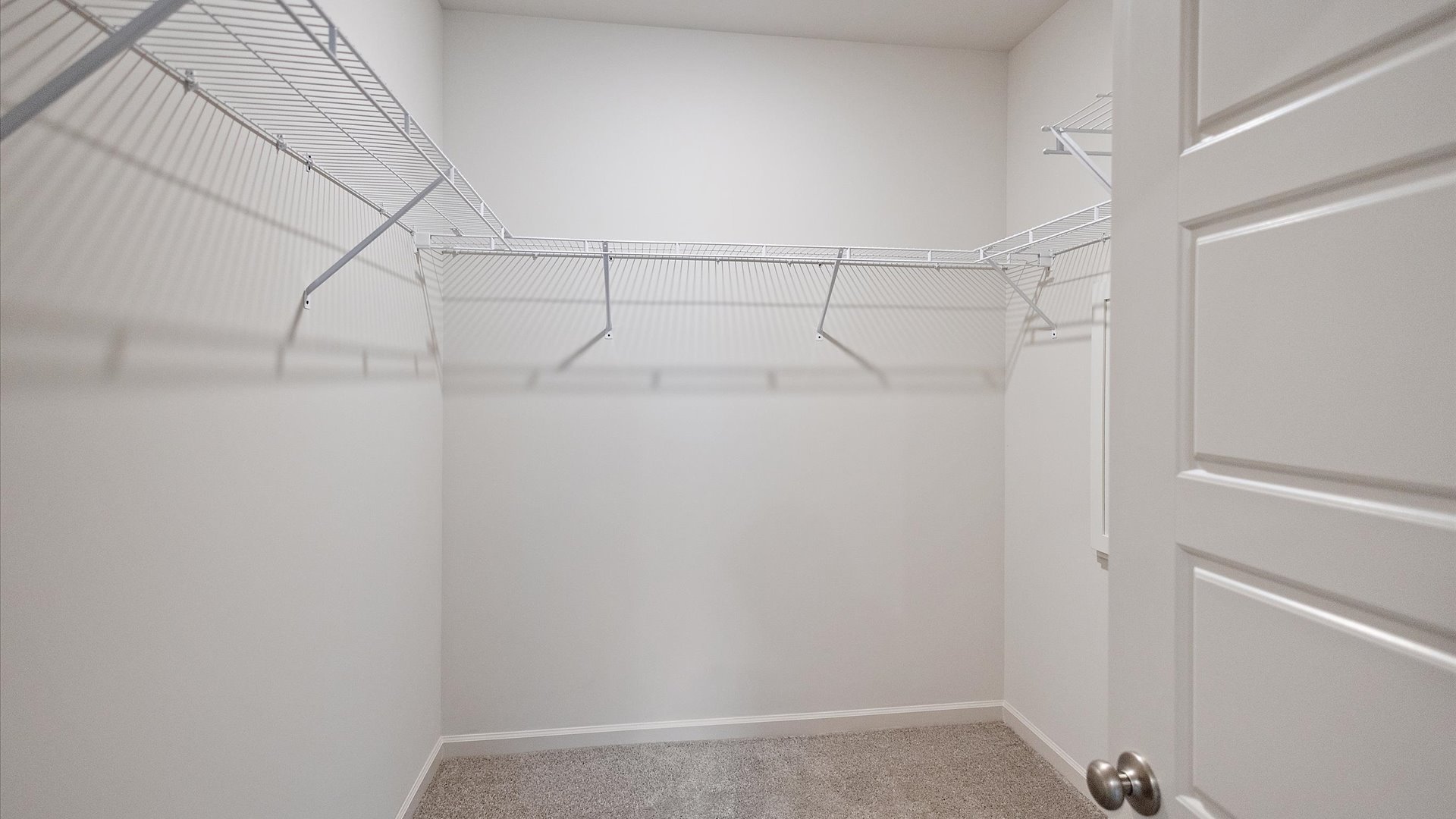 Walk-in closet with built-in shelving.