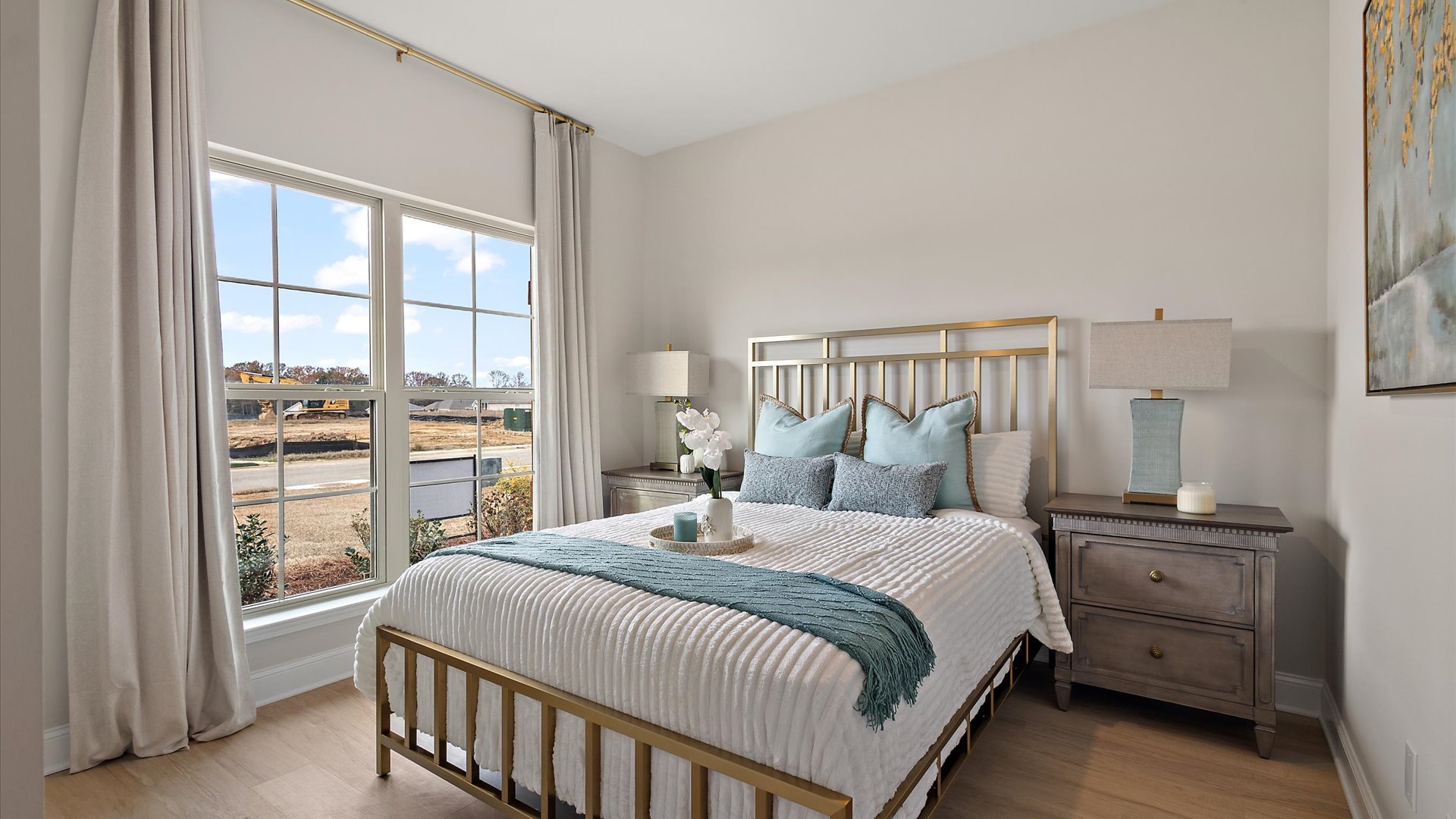 additional bedroom at front of home with hardwood floors and window for natural light