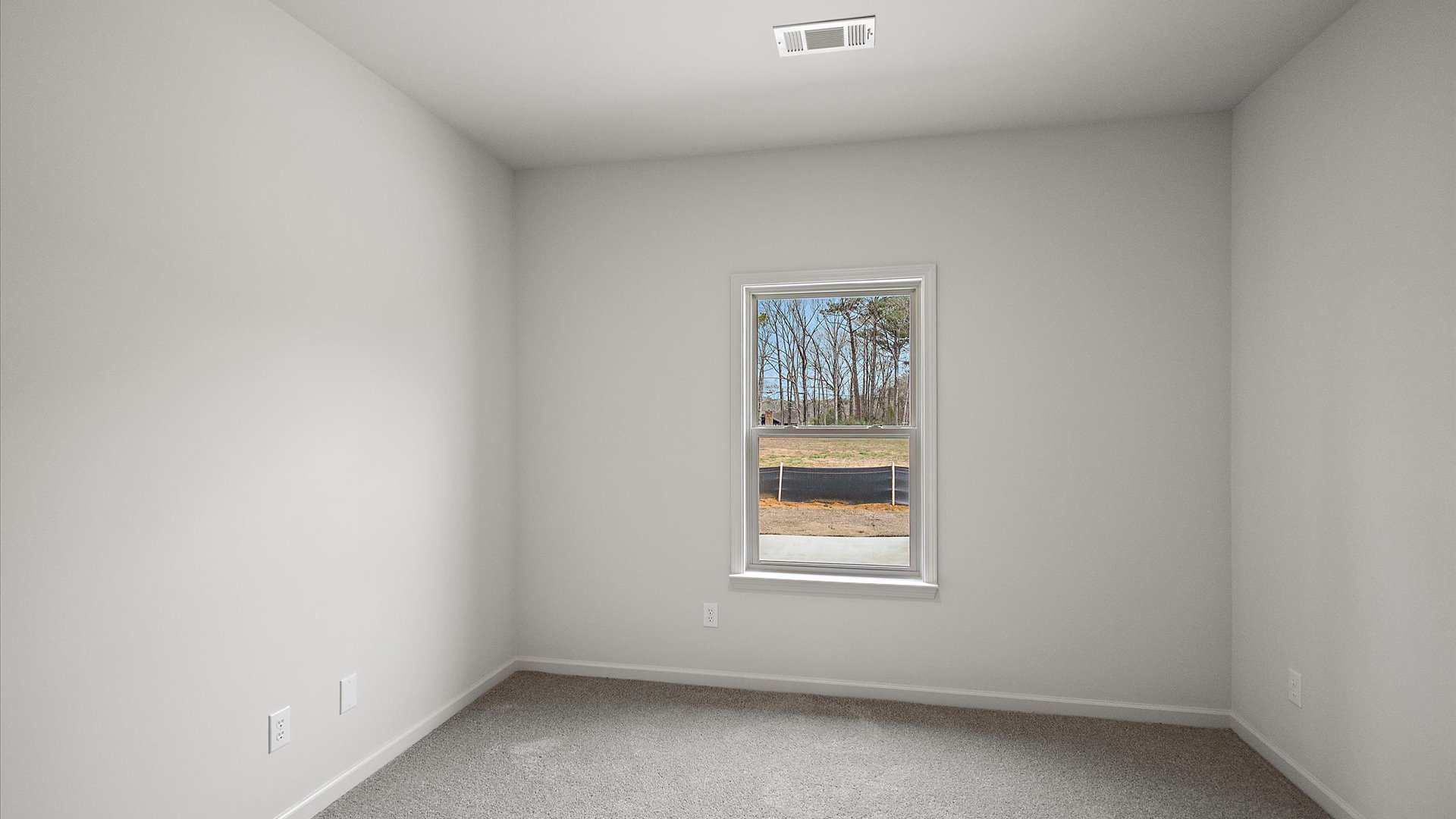 Additonal bedroom with carpeted floors, recessed lighting, and a window for natural light.
