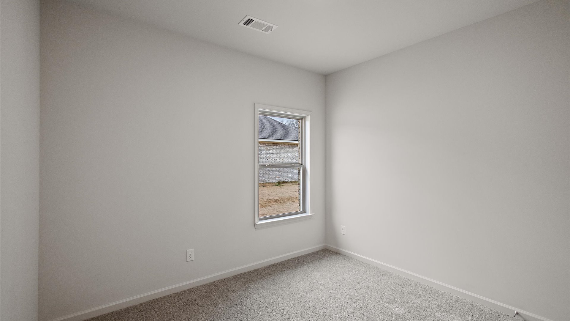 Additonal bedroom with carpeted floors, recessed lighting, and a window for natural light.