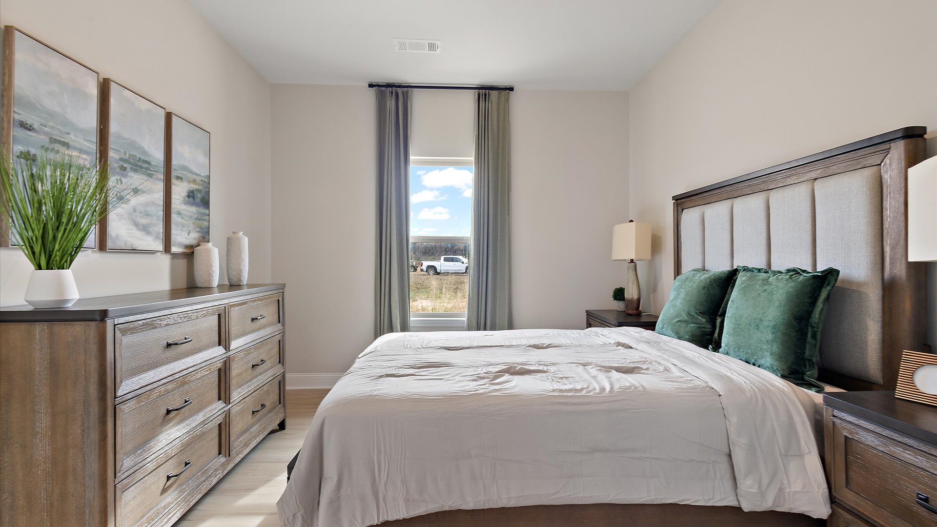 additional bedroom at front of home with hardwood floors and window for natural light