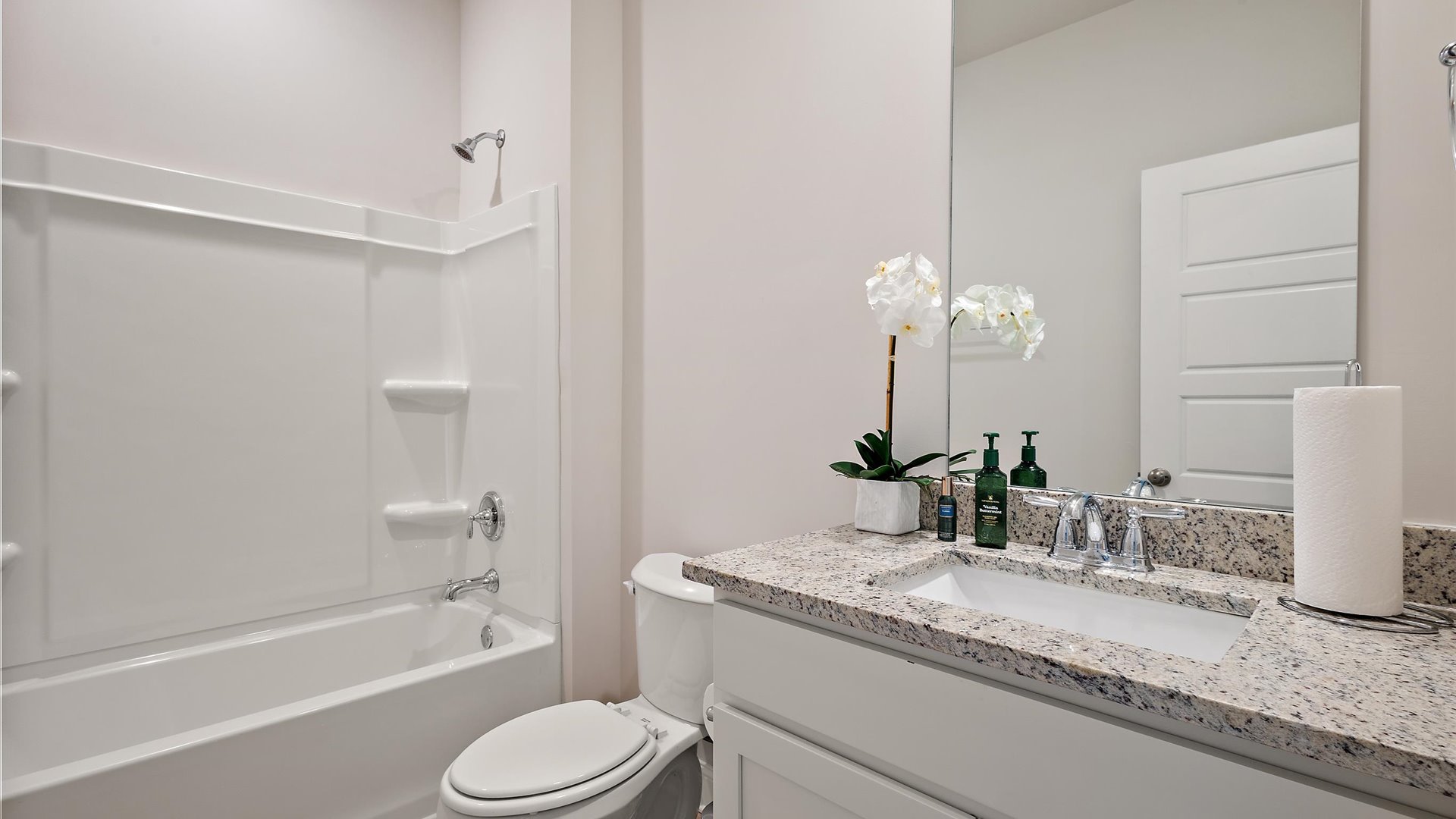 shared bathroom between bedrooms 2 and 3, single vanity, shower/tub combo