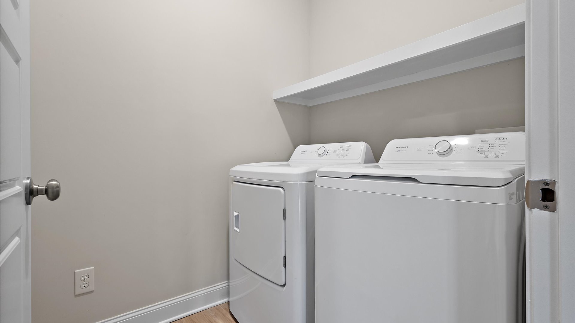 laundry space with wood shelving