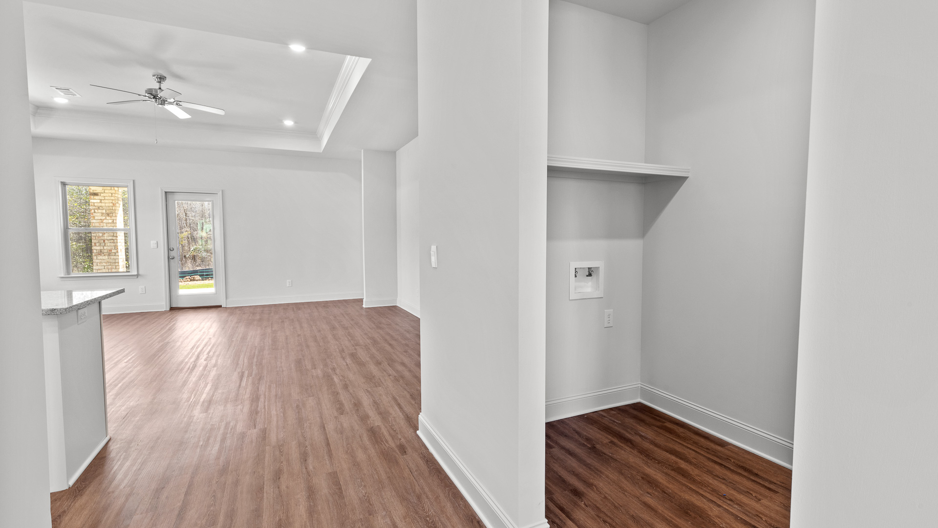 Laundry room with view of the living room.