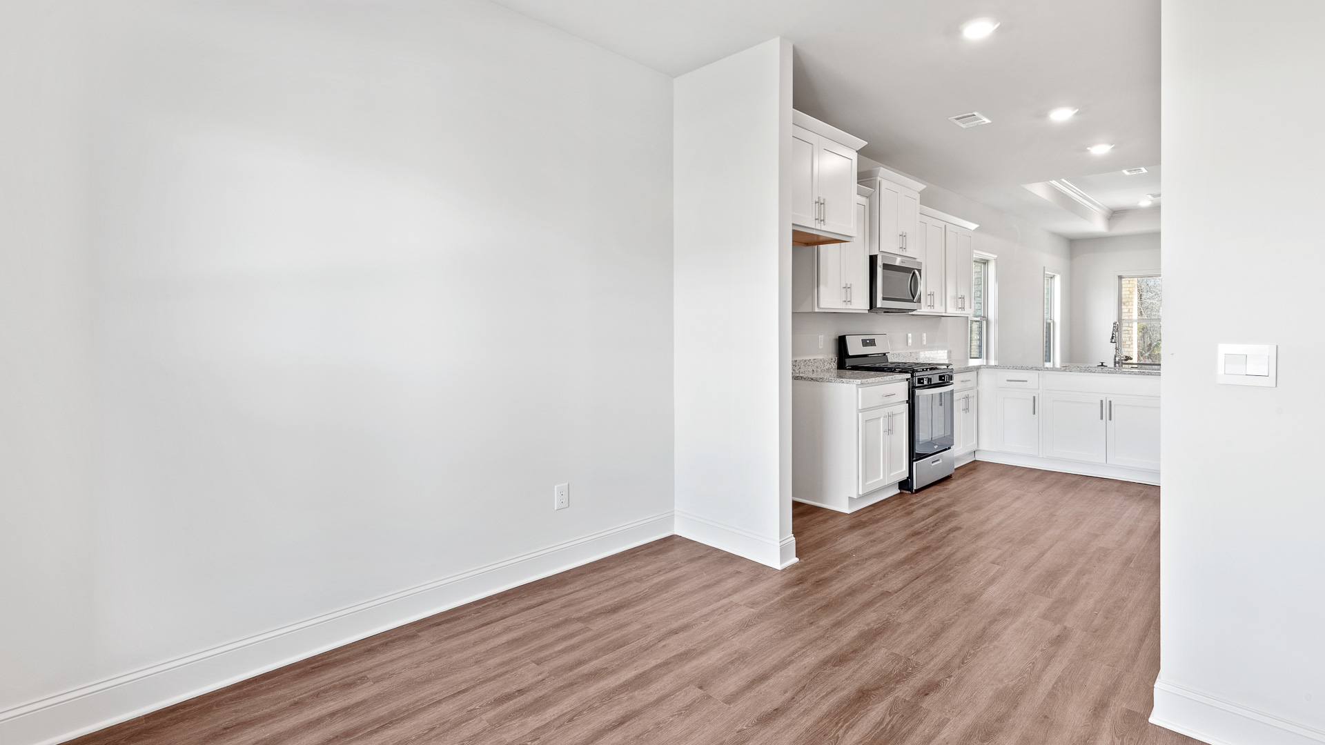 Dining room view of kitchen and living room.