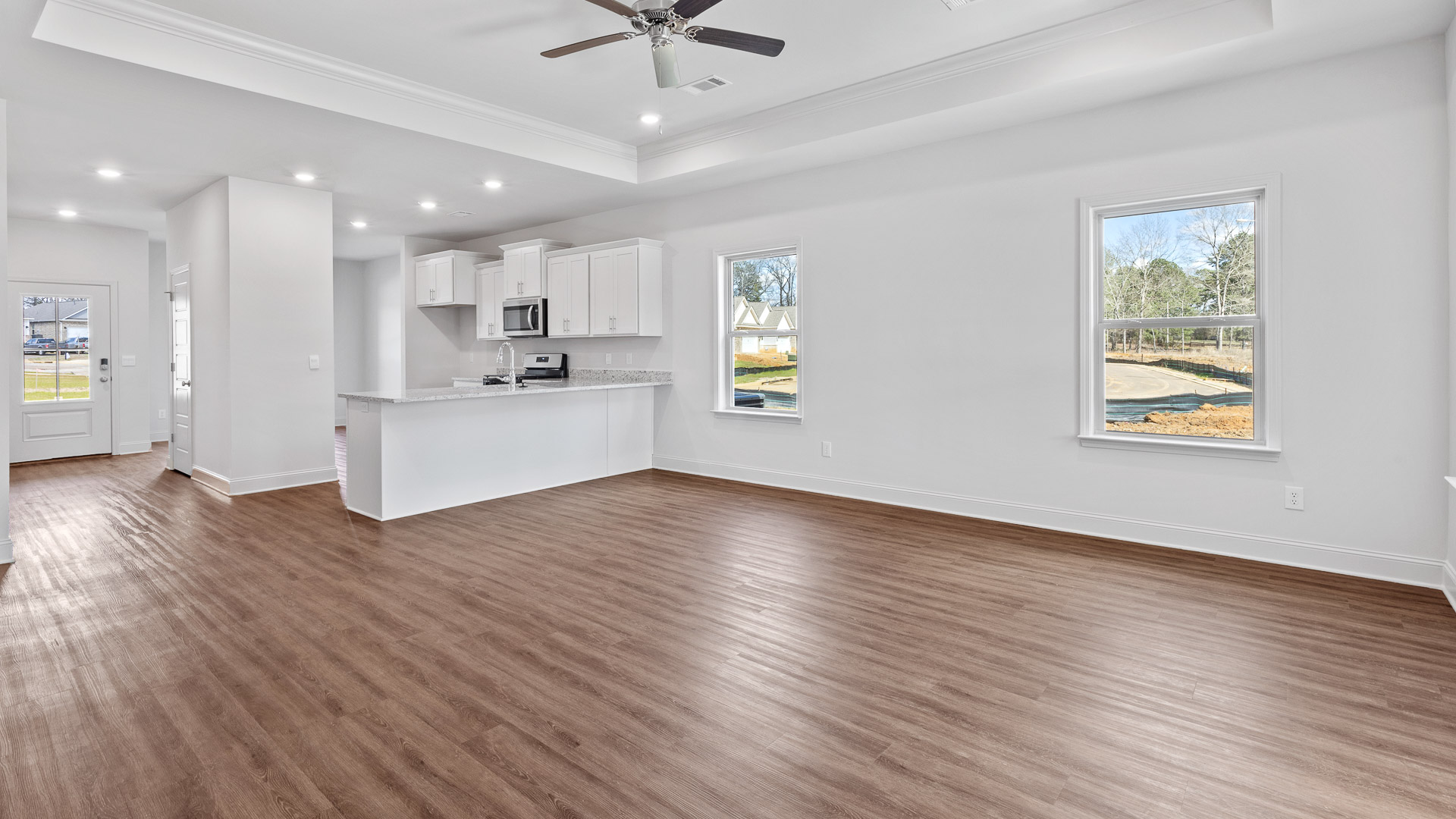 Living room view of the kitchen and entrance to the home.