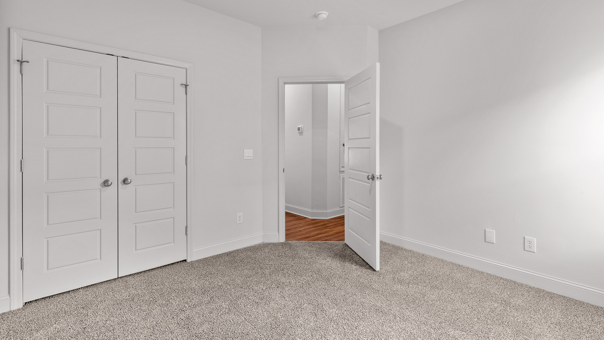 Carpeted bedroom three with a single window and a closet.