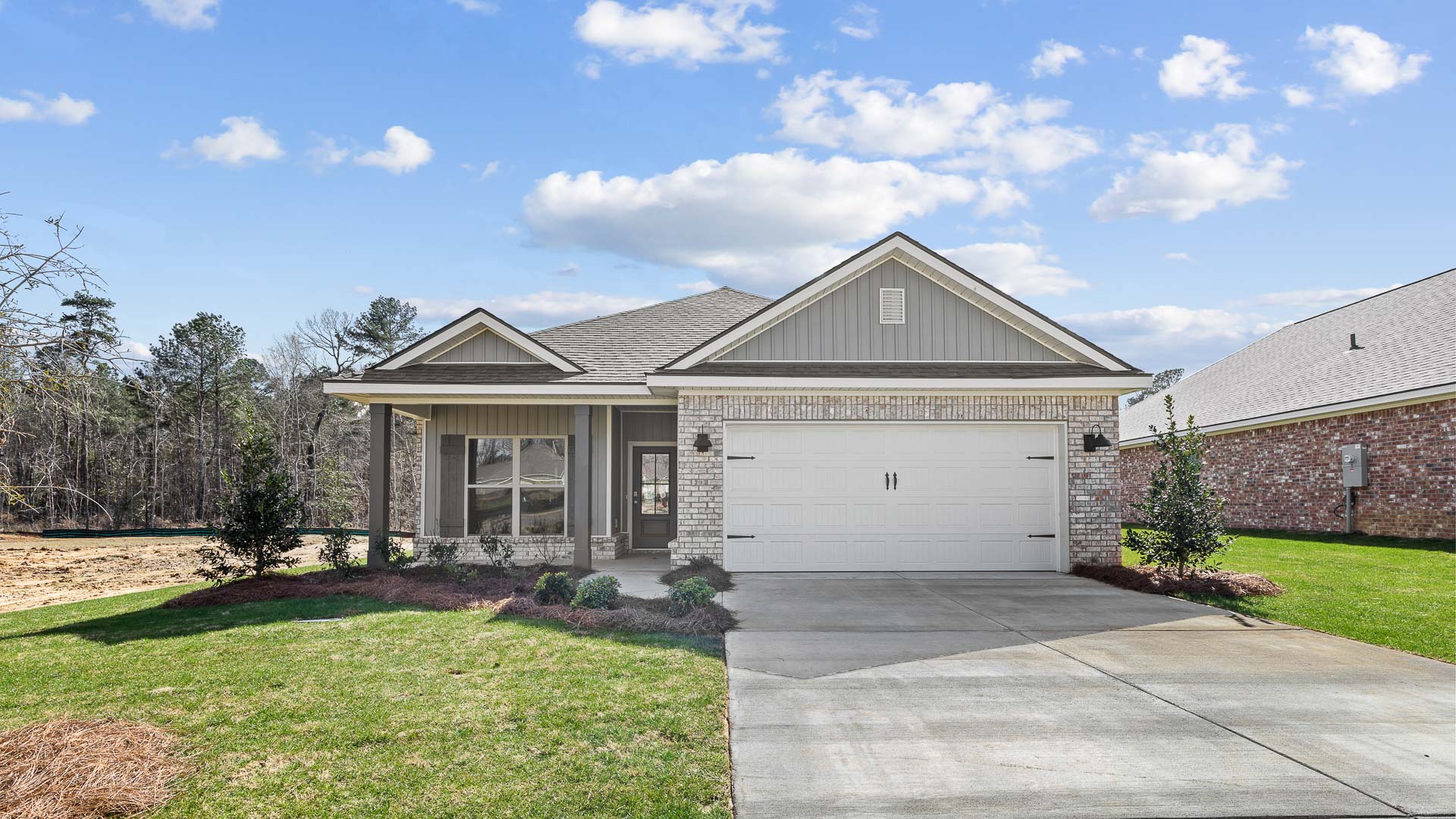 Single-story home with a front porch and two-car garage.
