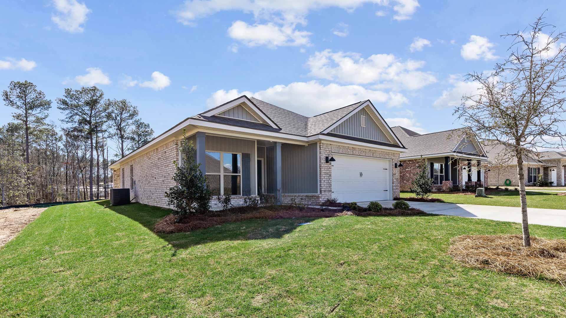 Single-story home with a front porch and two-car garage.