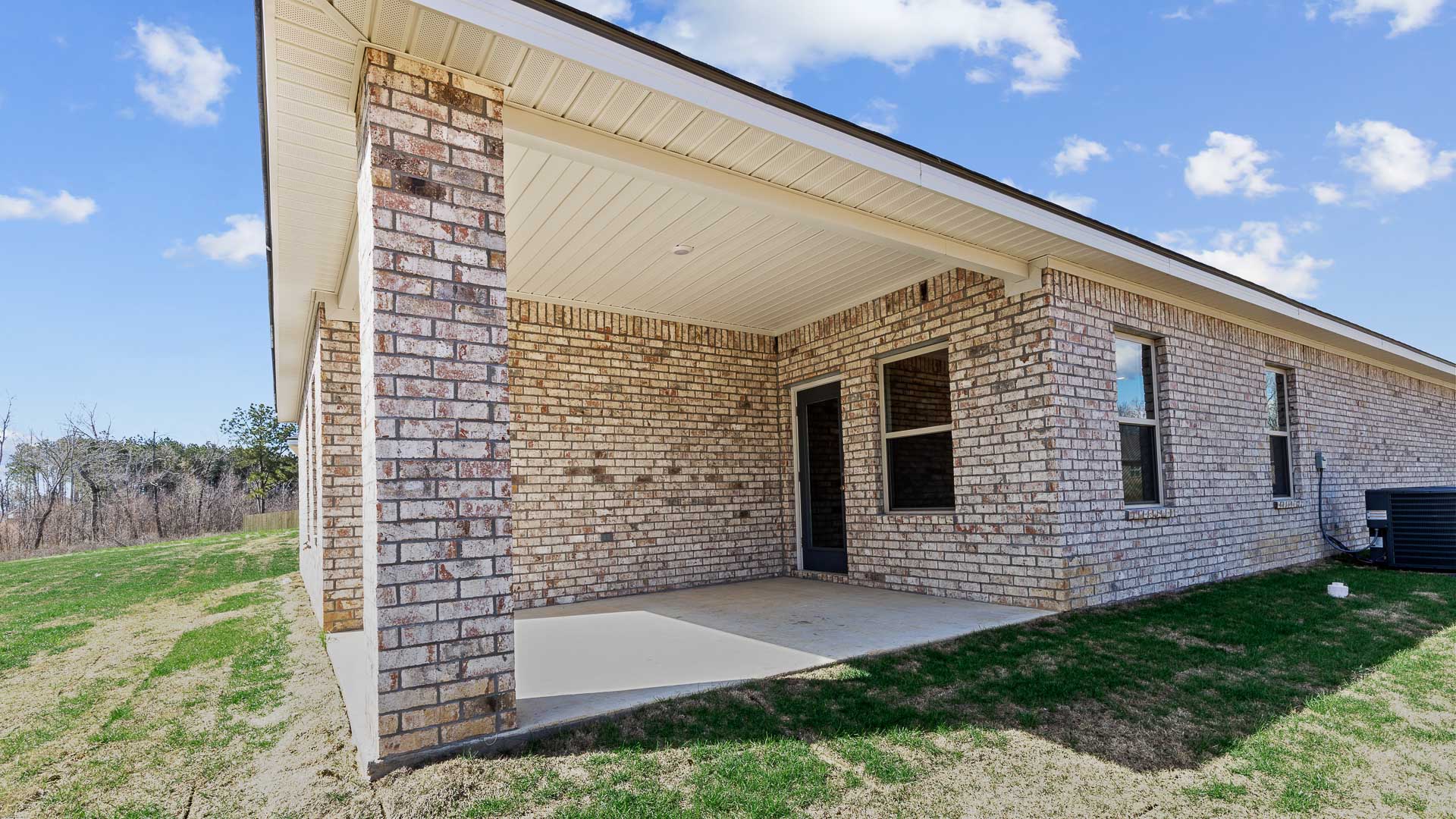 Covered back porch and rear exterior of home.