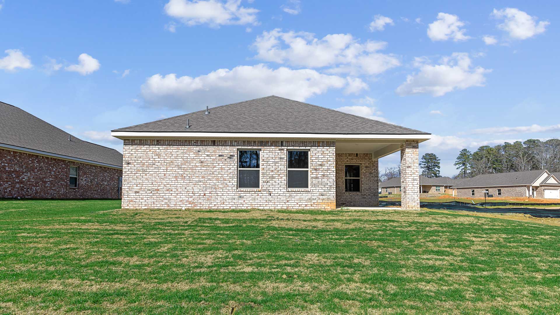 Covered back porch and rear exterior of home.