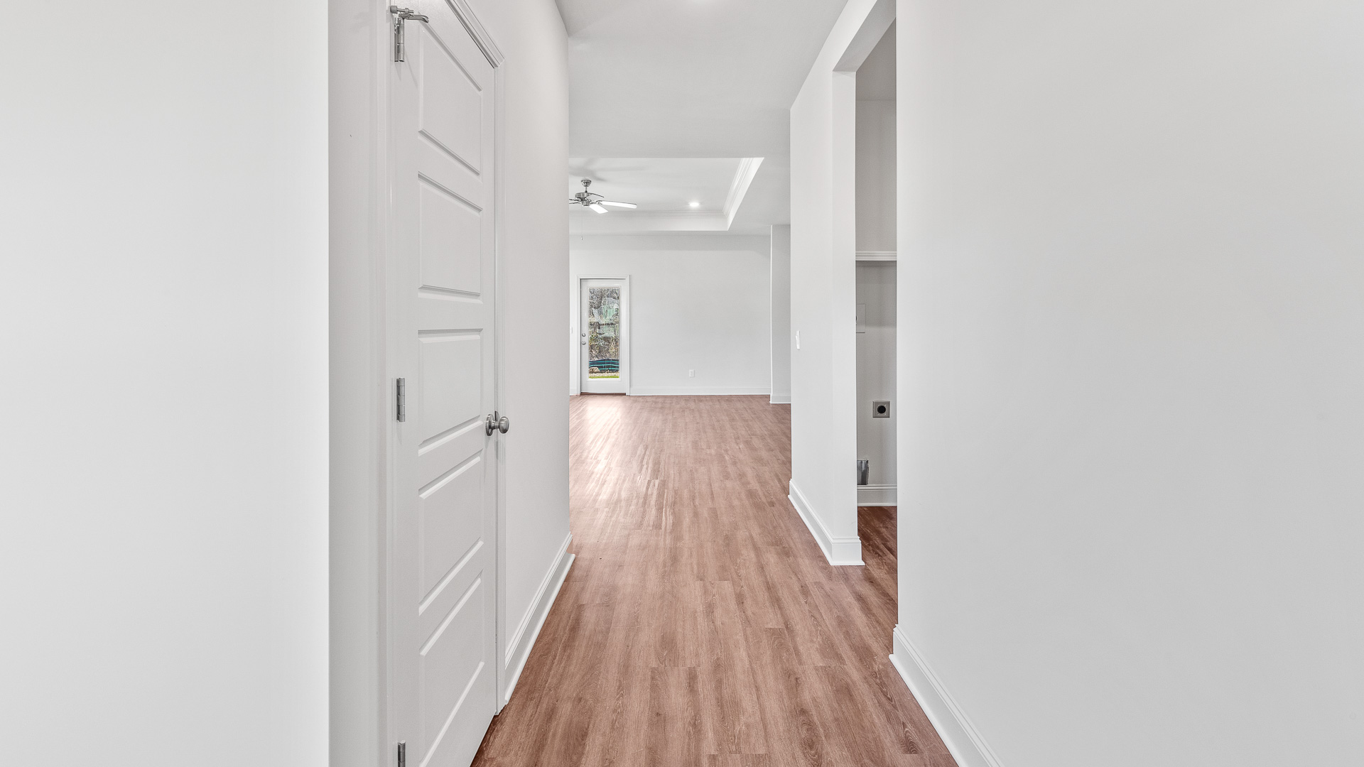 Entry hall has a view of the glass back door in the living room.
