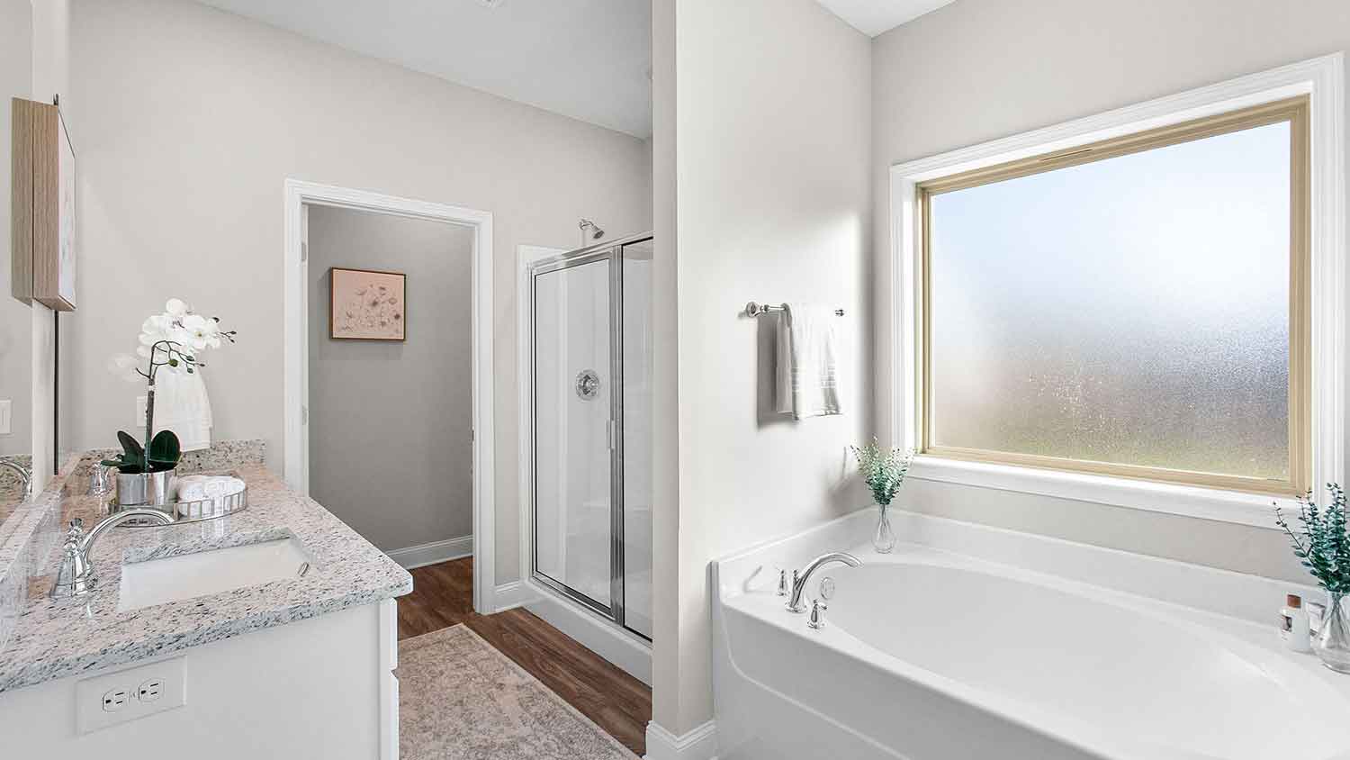 bathroom featuring a bathtub with a window above it