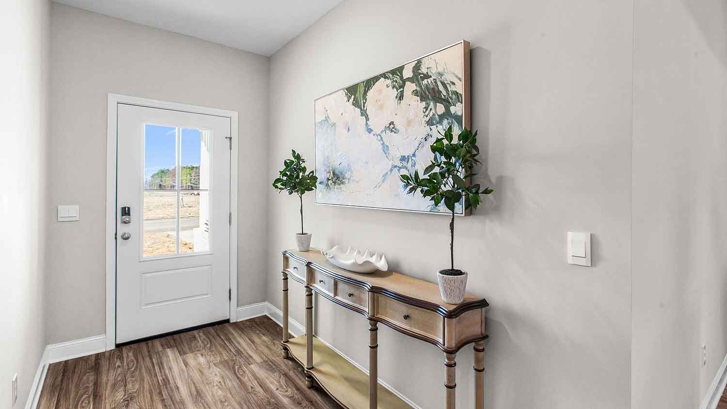 entry hallway featuring an entry table with a painting above it