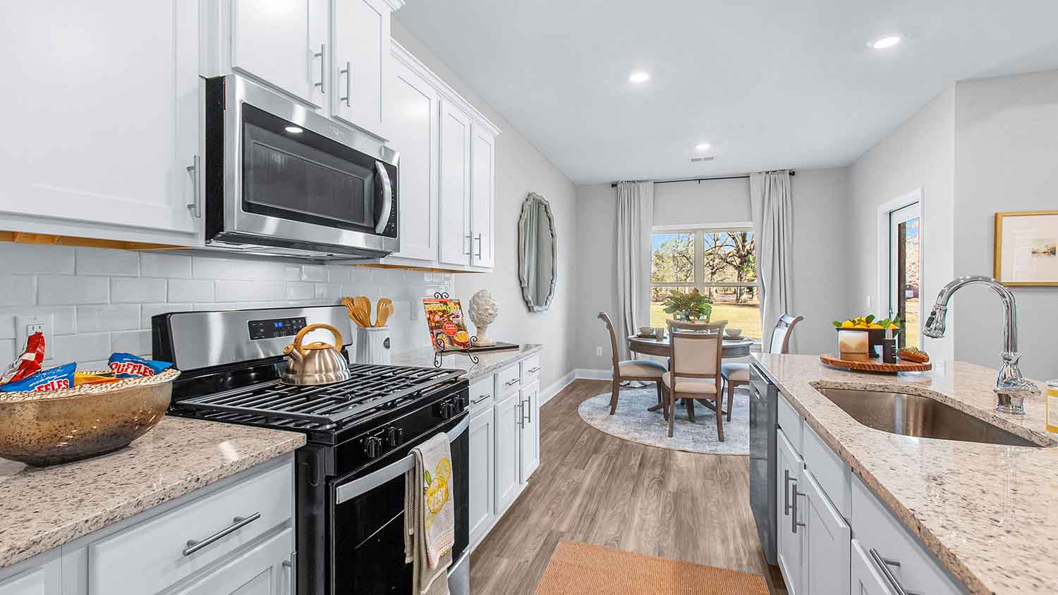 modern kitchen featuring a large island, white cabinetry, and stainless steel appliances