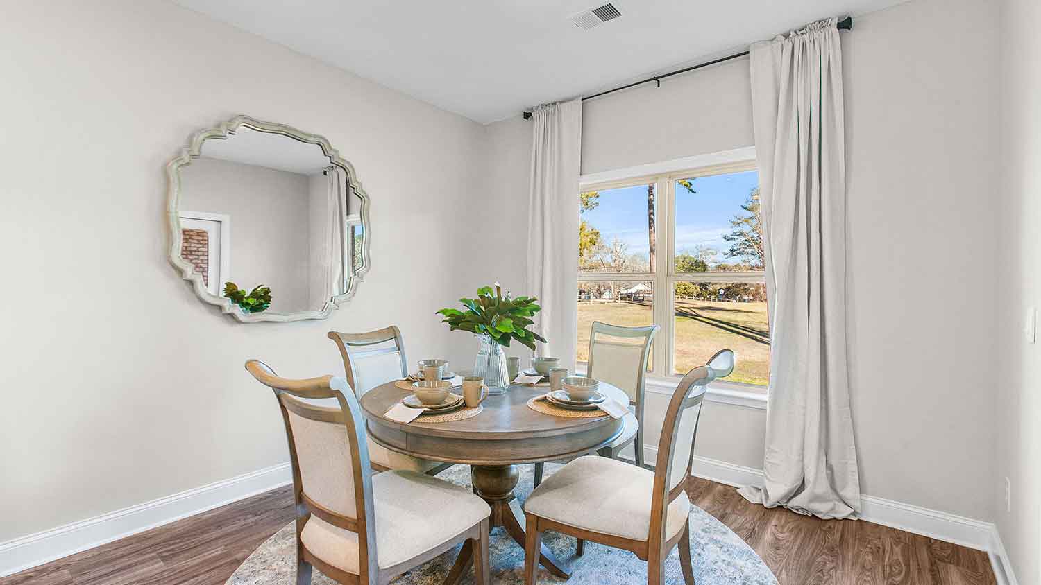 cozy dining area featuring a brown wooden table with four chairs