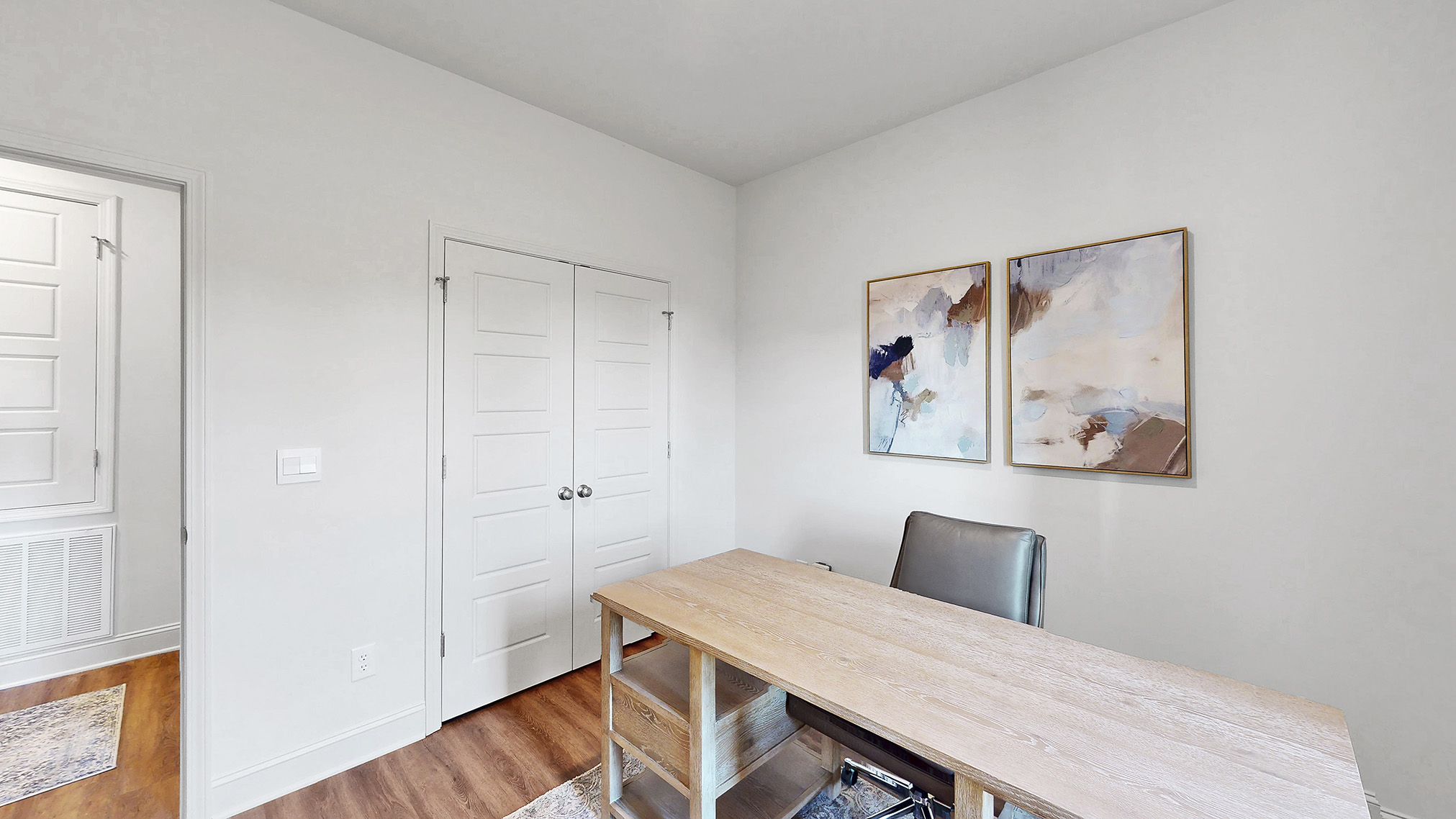 flex space being used as an office, with hardwood floors and window