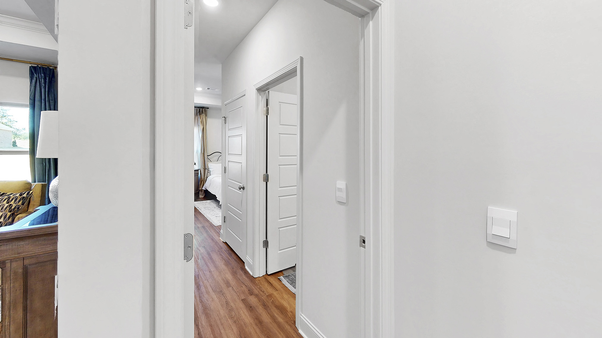 hall leading to additional bedrooms