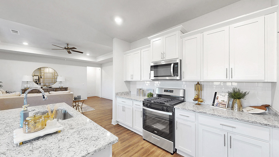 spacious kitchen with granite counters, soft close cabinets, and hardwood floors