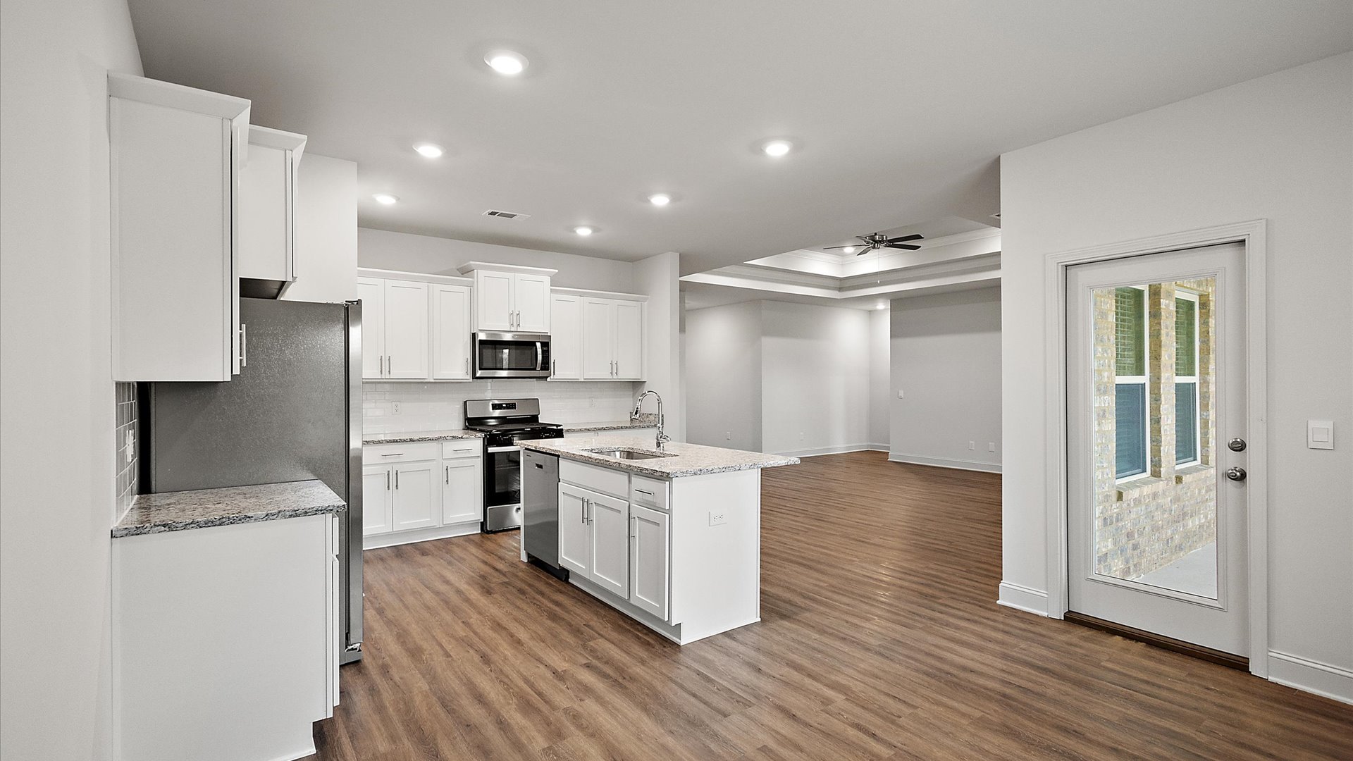 The open concept kitchen and the breakfast nook that open to the living room