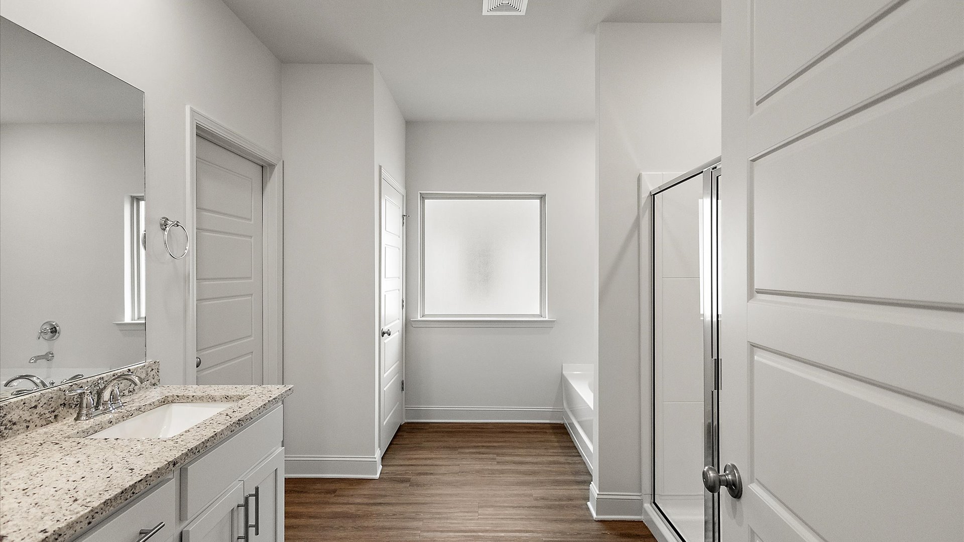 Primary bathroom features double vanity, walk-in shower, and garden tub.