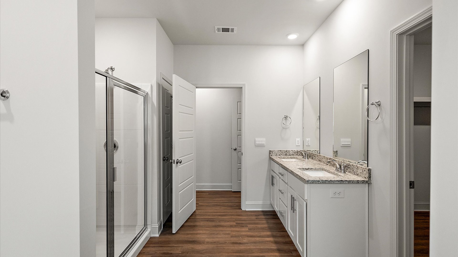 Primary bathroom showcasing a double vanity and walk-in shower.