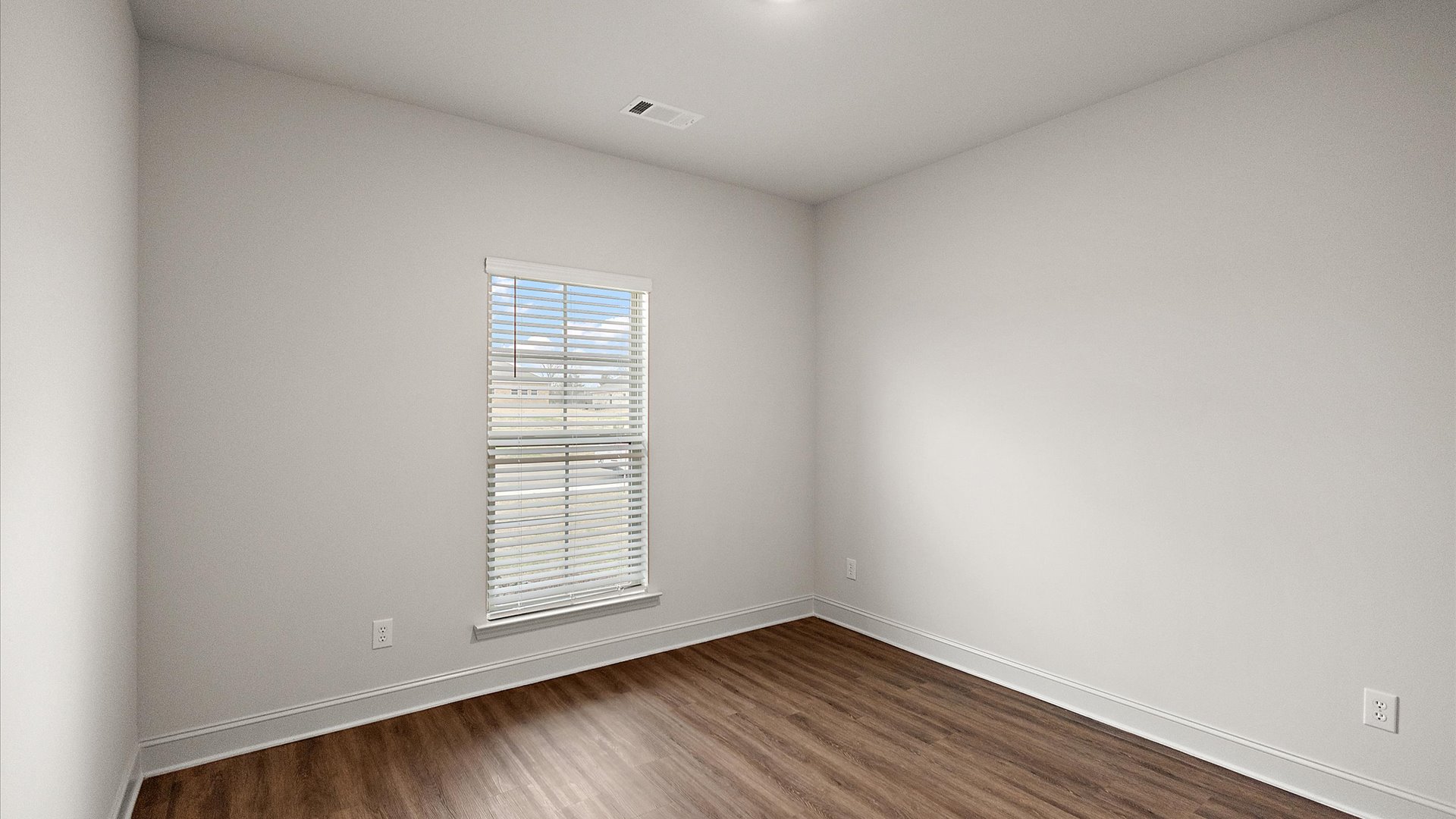 Bedroom has hardwood floors, window for natural light, and recessed lighting.